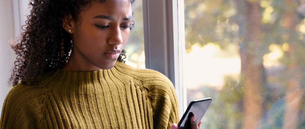 Concerned woman looking at phone