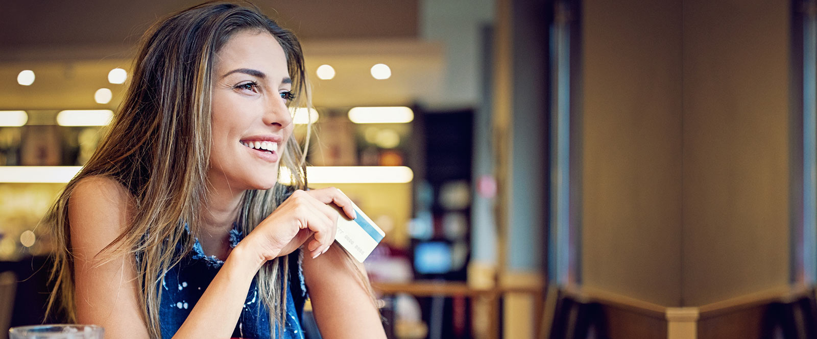 Person using a debit card to pay for their coffee.