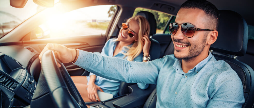 Couple riding in a new car.